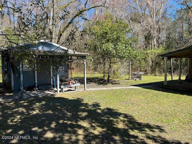 18455 Ware Avenue Jacksonville, FL 32234 - Photo 7 of 8 a view of a house with backyard and sitting area