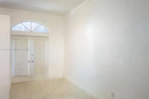 a kitchen with refrigerator and cabinets
