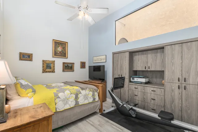 a bedroom with a bed and a chandelier