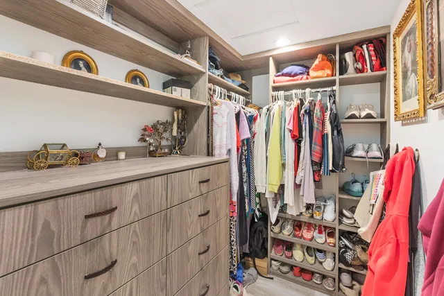 a view of walk in closet with clothes