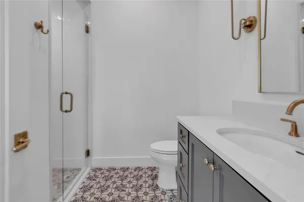 a spacious bathroom with a granite countertop sink mirror and toilet