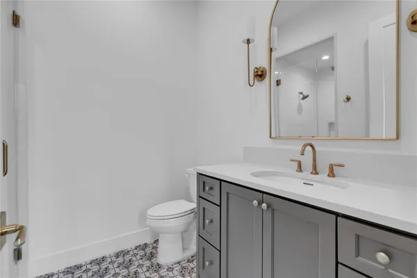 a bathroom with a bathtub sink shower and mirror