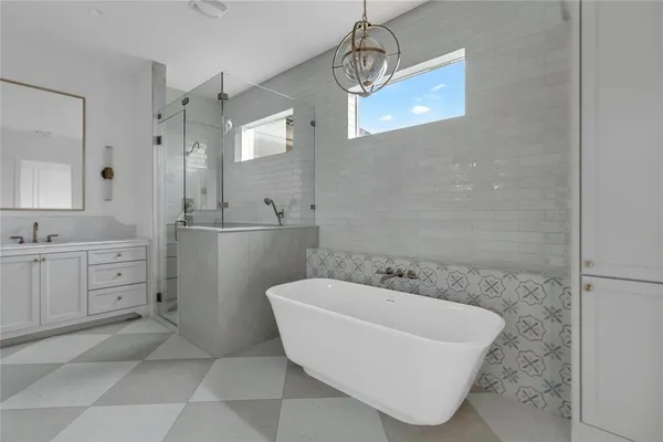 a spacious bathroom with a sink and a mirror
