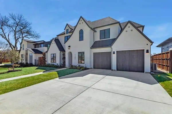 a large kitchen with kitchen island granite countertop a large center island a sink and a wooden floor