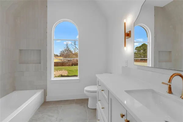 a view of an empty room with a fireplace and a window