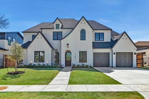 a large kitchen with kitchen island white cabinets and stainless steel appliances