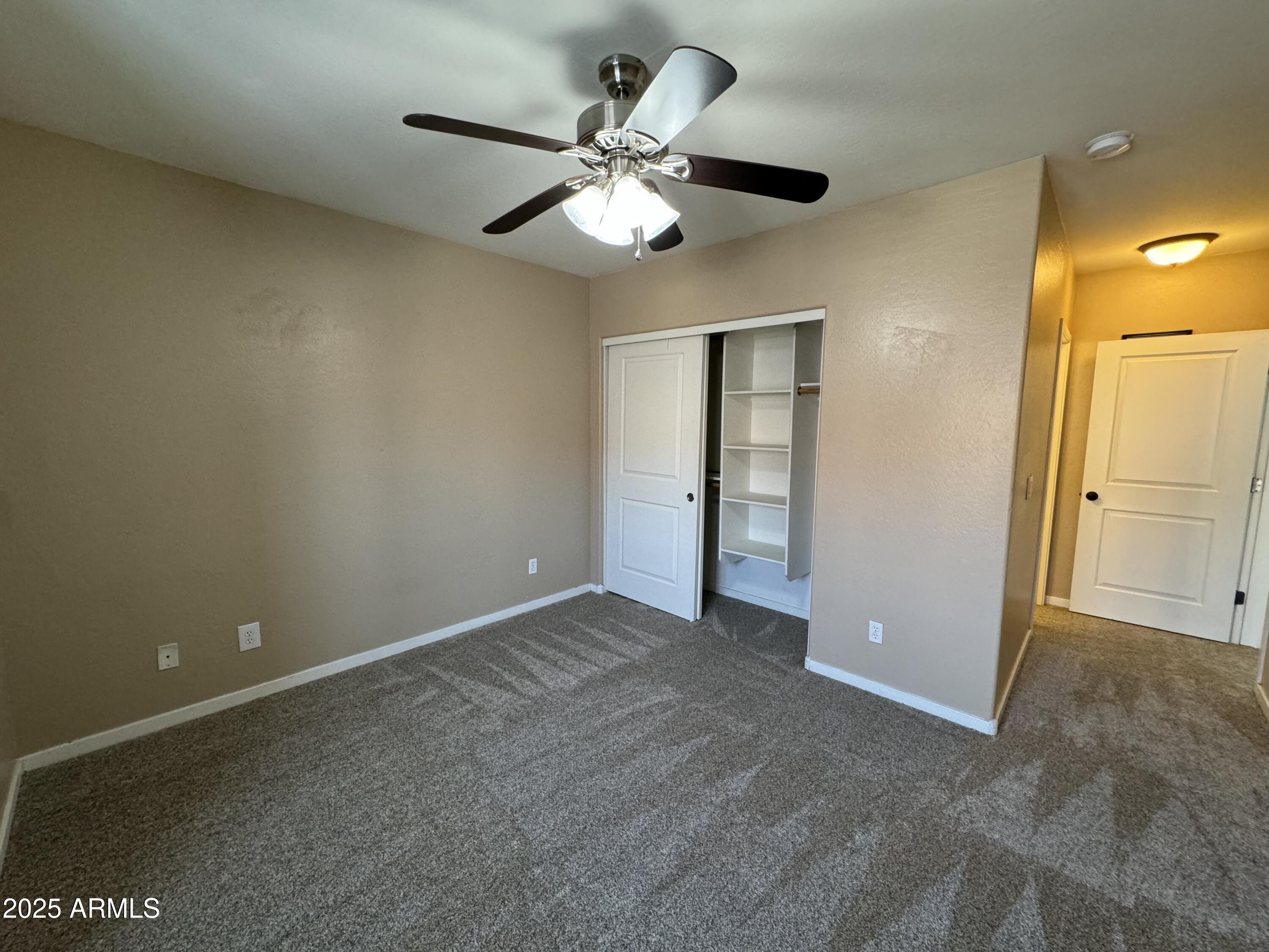 305 South Wilson Street, Unit 111 Tempe, AZ 85281 - Photo 33 of 48 an empty room with closet and a chandelier fan