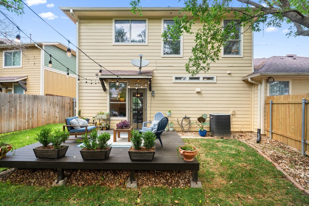 6708 Menchaca Road, Unit 2 Austin, TX 78745 - Photo 29 of 30 Expansive backyard featuring a multi-level wood deck, a manicured lawn, and a privacy fence
