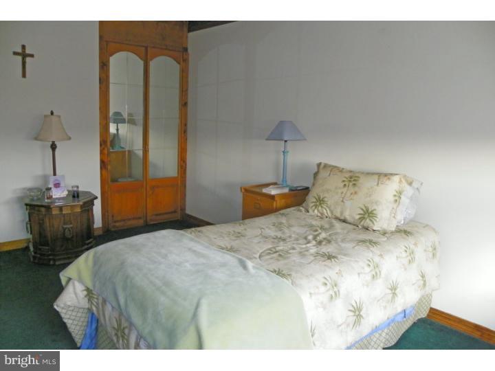 3215 Byberry Road Philadelphia, PA 19154 - Photo 14 of 25 a bedroom with a bed and a lamp