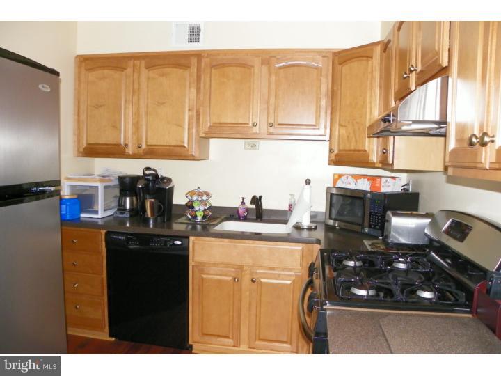 3215 Byberry Road Philadelphia, PA 19154 - Photo 10 of 25 a kitchen with stainless steel appliances a stove a sink dishwasher and cabinets with wooden floor