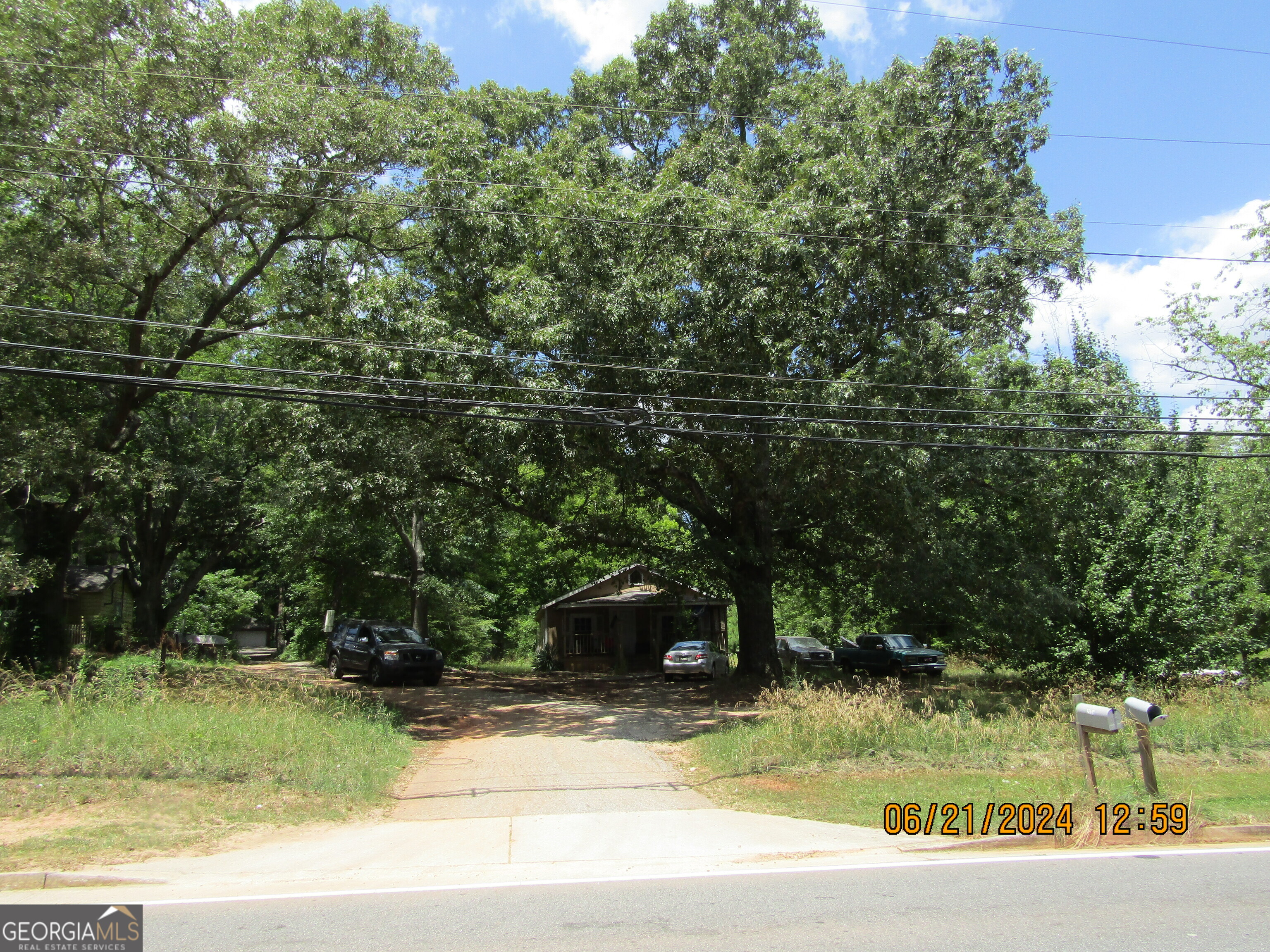 2169 Panola Road Lithonia, GA 30058 - Photo 3 of 10 a view of a yard in front of a house with large trees