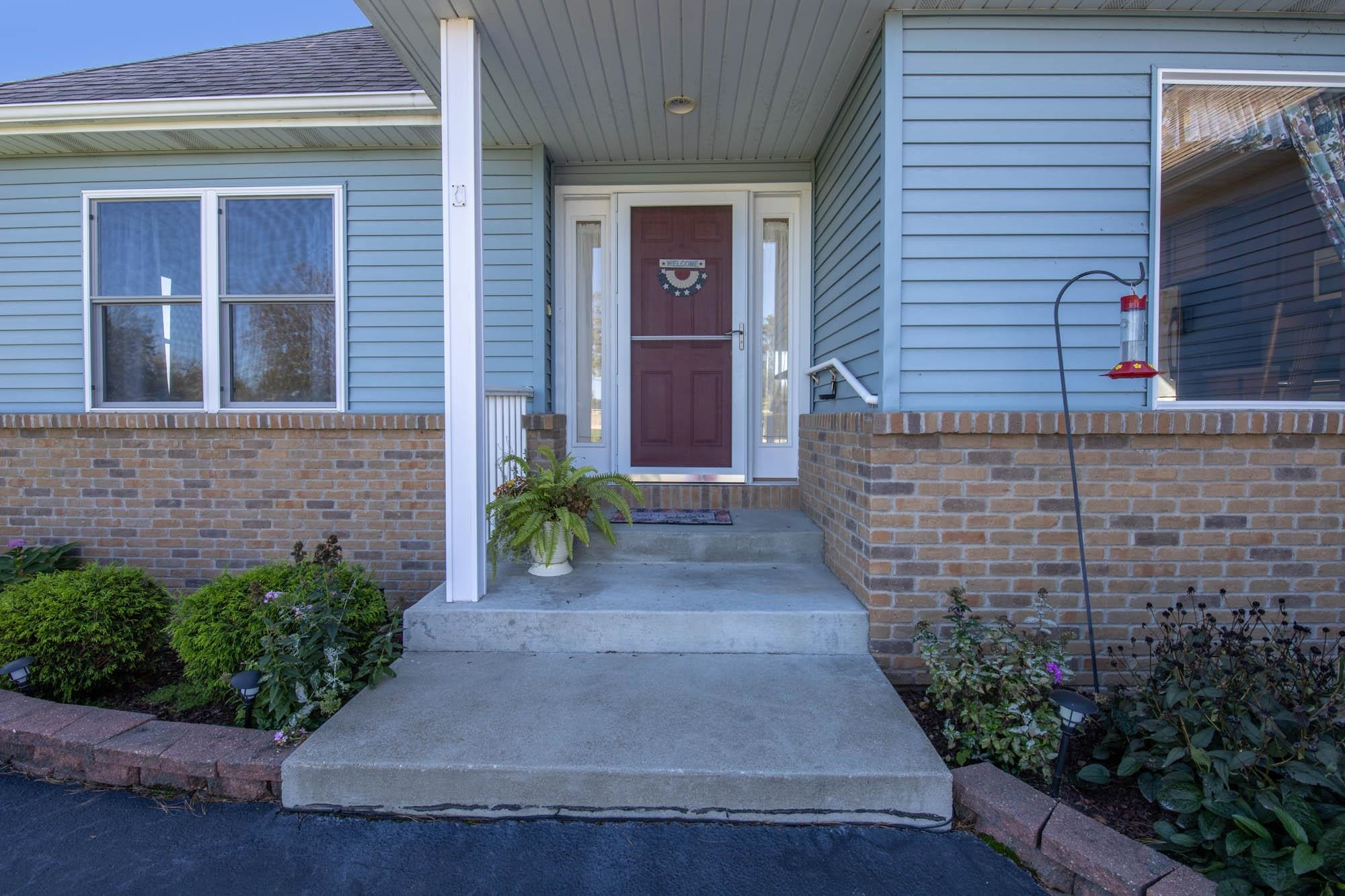2107 Lake Summerset Road Lake Summerset, IL 61019 - Photo 2 of 33 a view of front of a house with potted plants