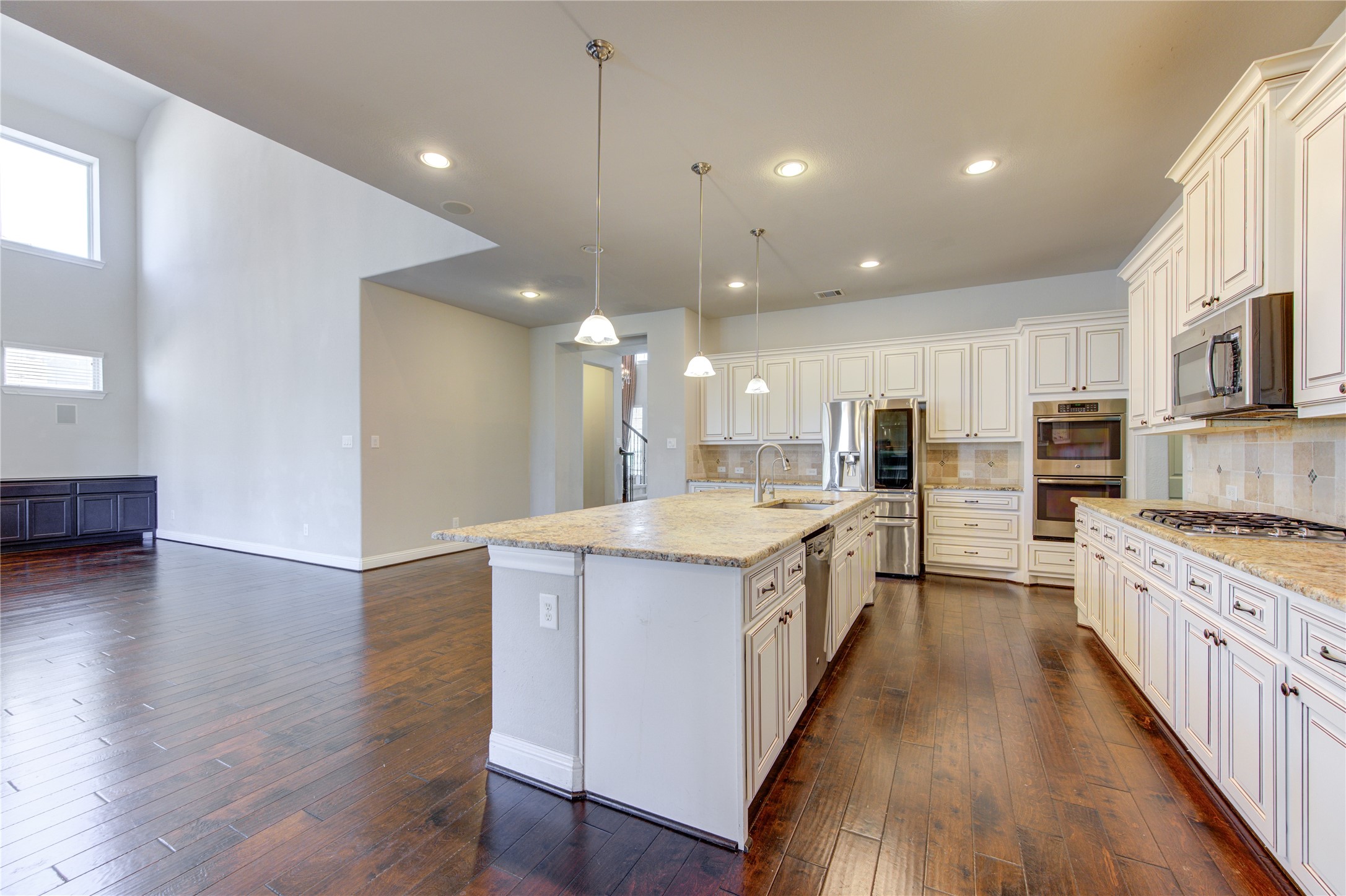 20411 Fawn Rest Place Spring, TX 77379 - Photo 14 of 50 a large kitchen with stainless steel appliances lots of counter space and wooden floor