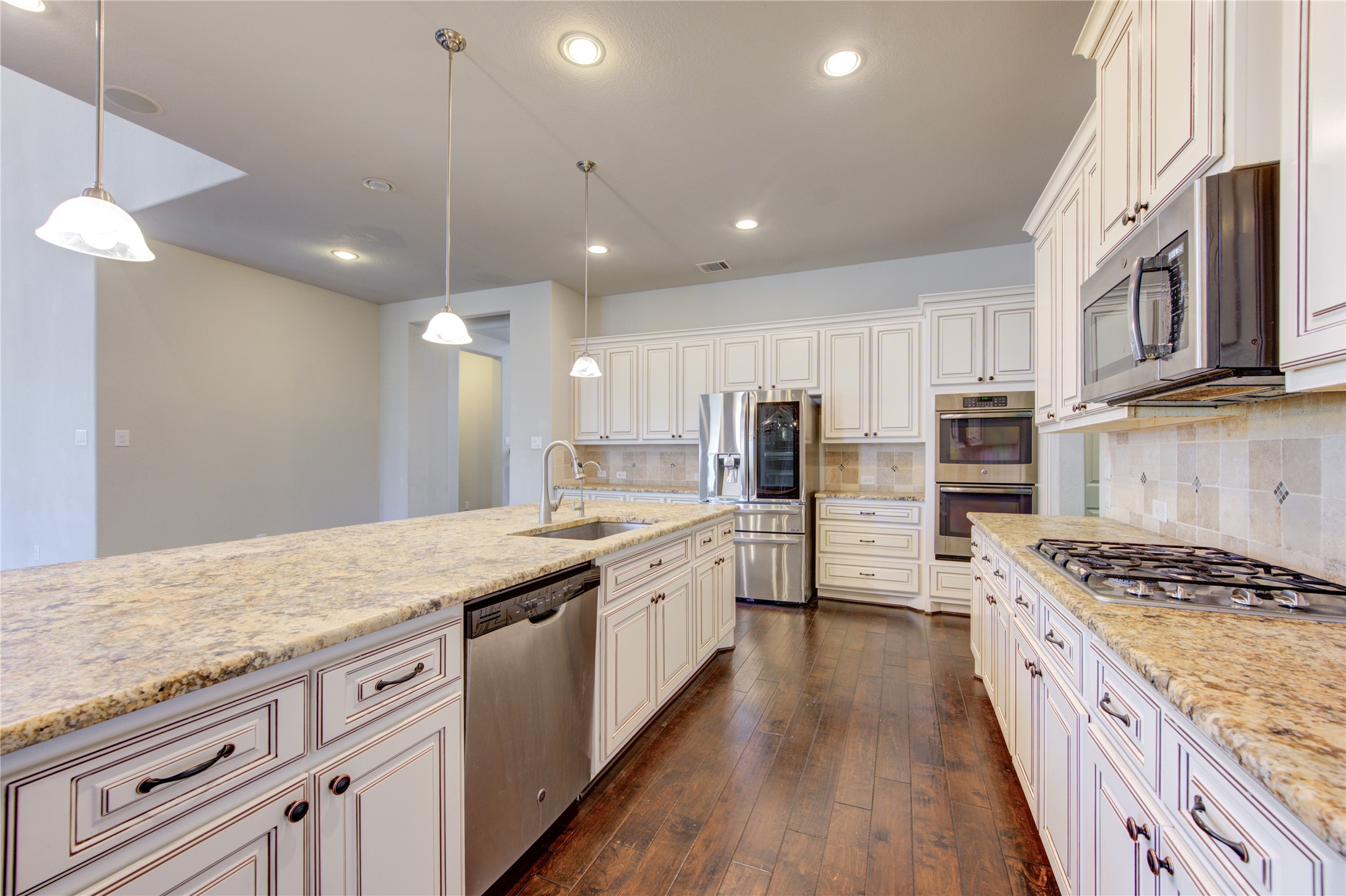 20411 Fawn Rest Place Spring, TX 77379 - Photo 15 of 50 a large kitchen with stainless steel appliances granite countertop a lot of counter space and wooden floors