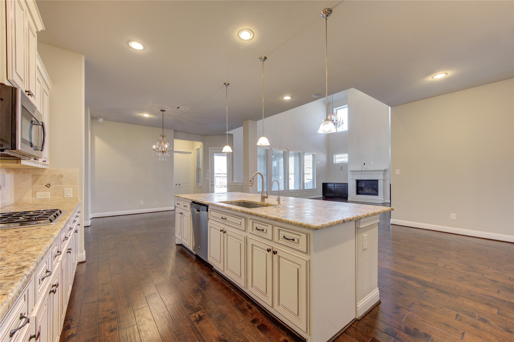 20411 Fawn Rest Place Spring, TX 77379 - Photo 16 of 50 a kitchen with stainless steel appliances granite countertop a sink a stove and a wooden floors