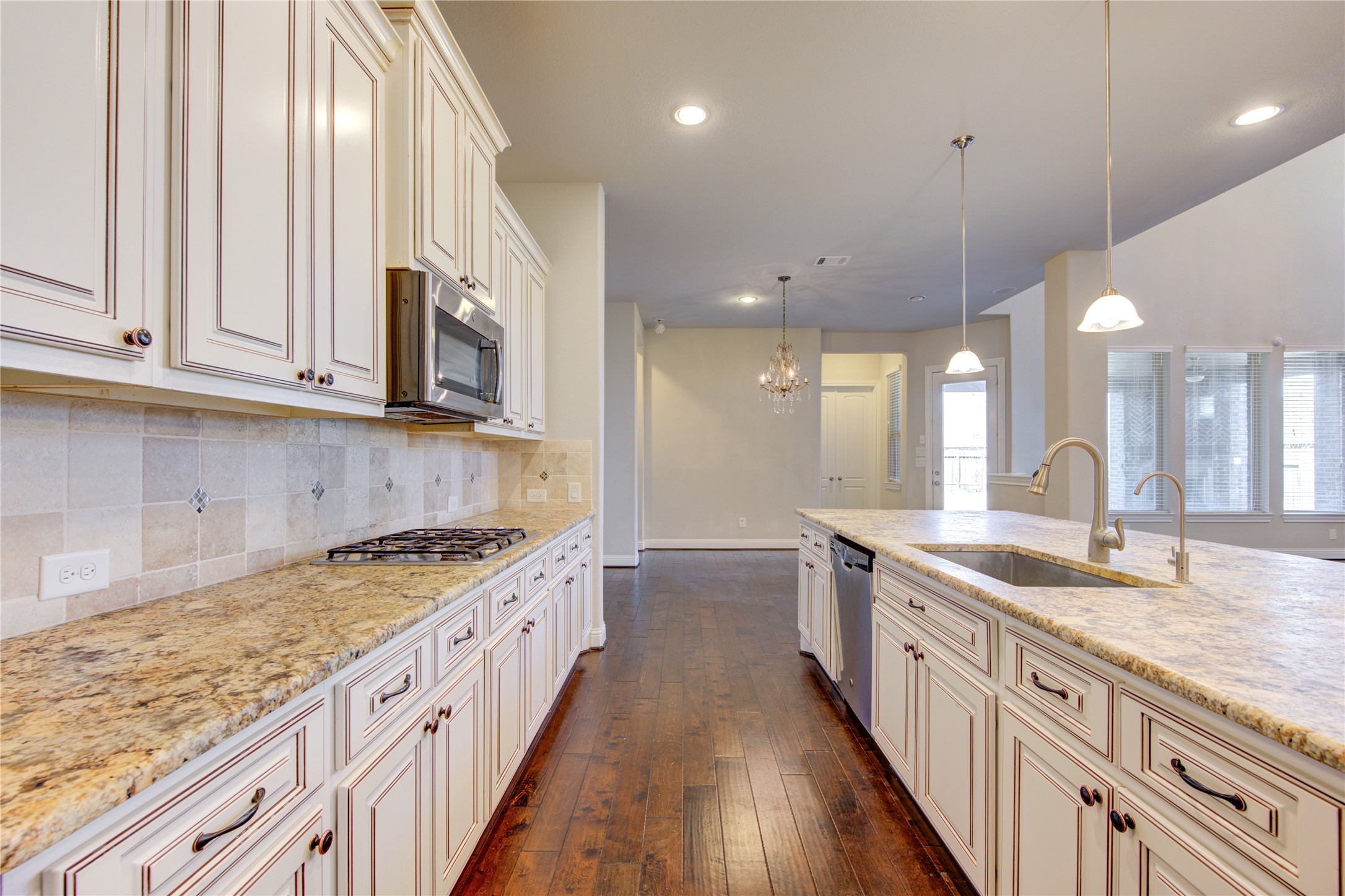 20411 Fawn Rest Place Spring, TX 77379 - Photo 17 of 50 a kitchen with stainless steel appliances granite countertop a sink a stove and a wooden floors