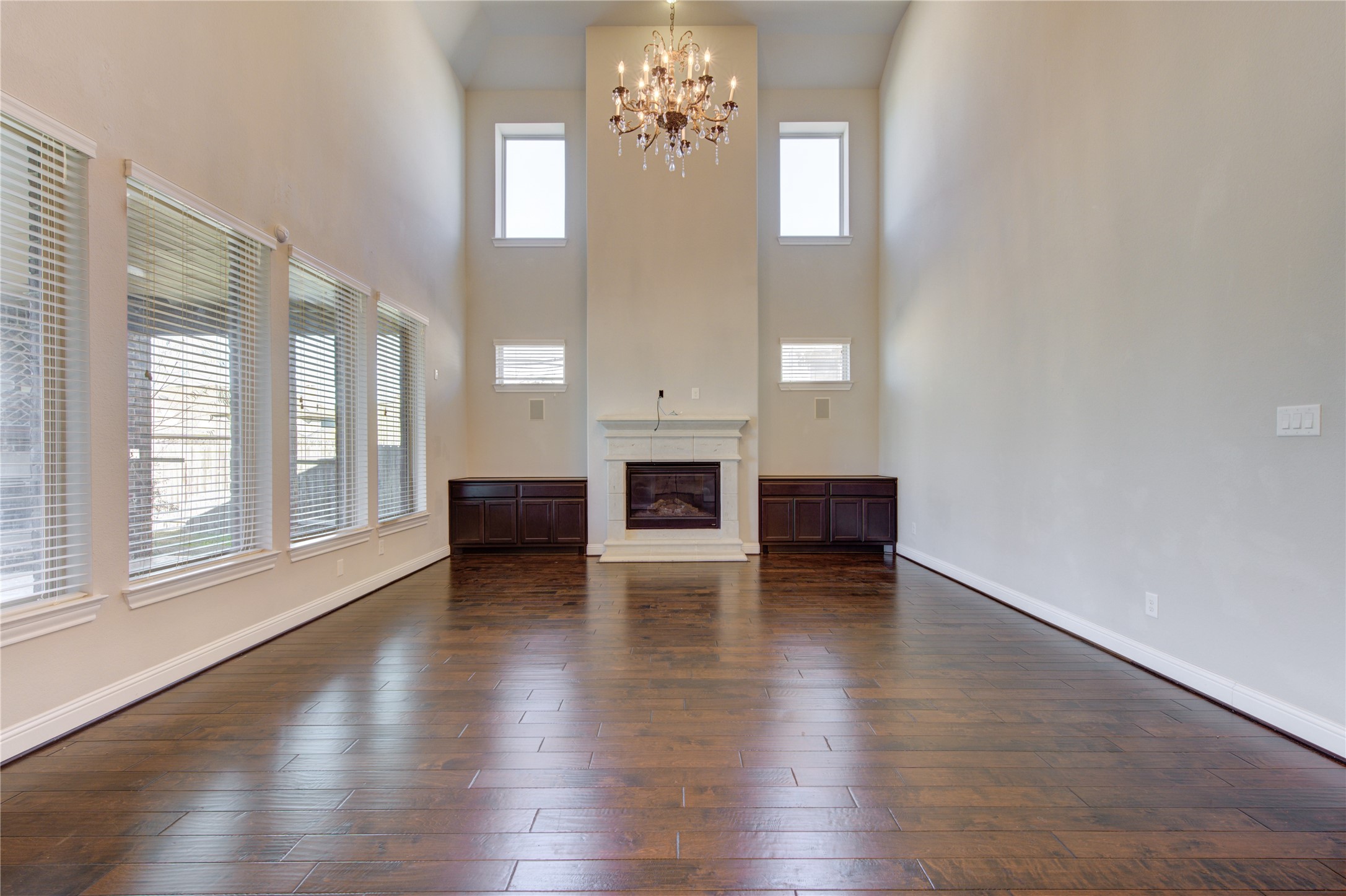 20411 Fawn Rest Place Spring, TX 77379 - Photo 19 of 50 an empty room with wooden floor fireplace and windows