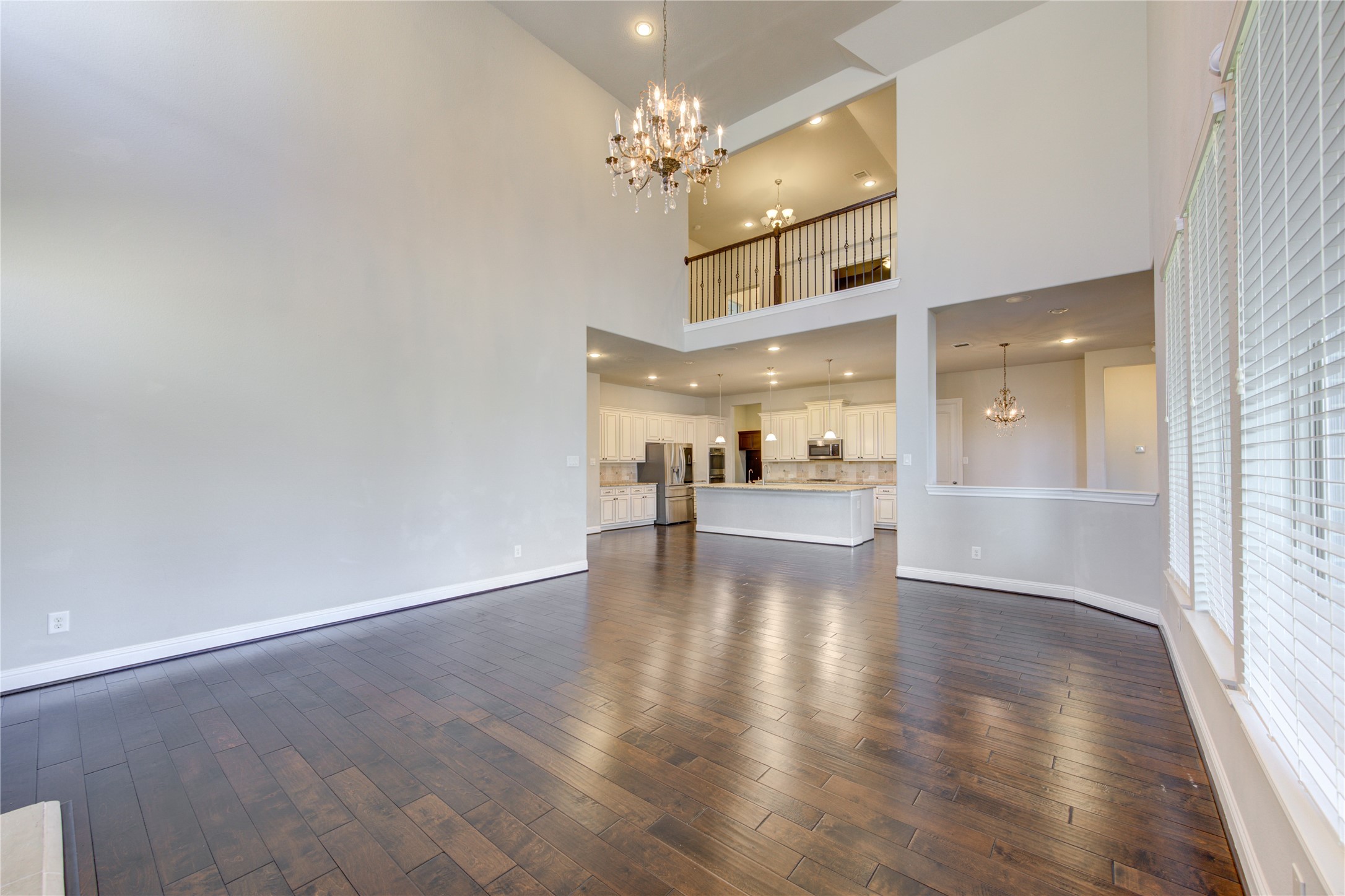 20411 Fawn Rest Place Spring, TX 77379 - Photo 21 of 50 a view of a hallway with wooden floor and a kitchen
