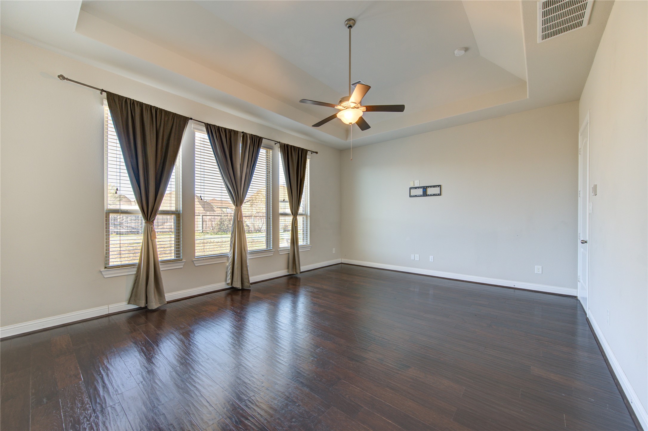 20411 Fawn Rest Place Spring, TX 77379 - Photo 27 of 50 an empty room with wooden floor fan and windows