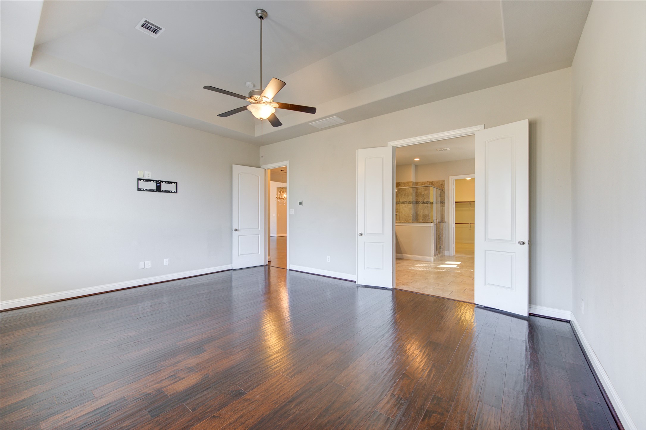 20411 Fawn Rest Place Spring, TX 77379 - Photo 28 of 50 a view of an empty room with wooden floor and a ceiling fan