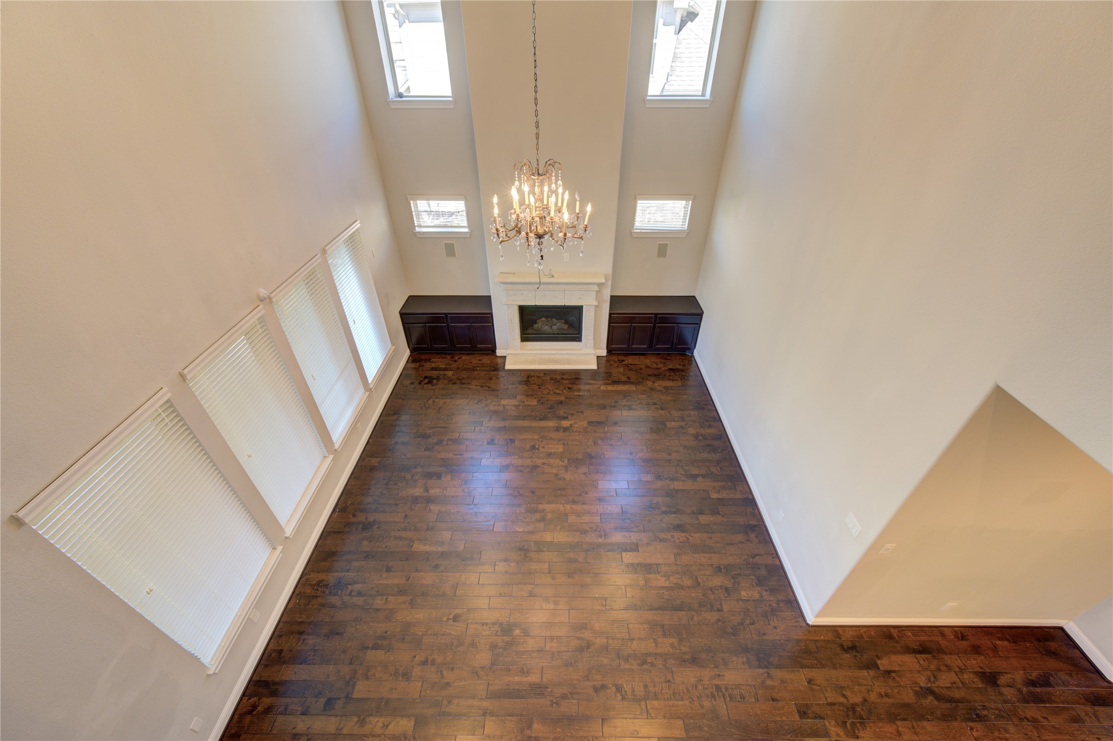 20411 Fawn Rest Place Spring, TX 77379 - Photo 46 of 50 a view of a hallway with wooden floor and a chandelier