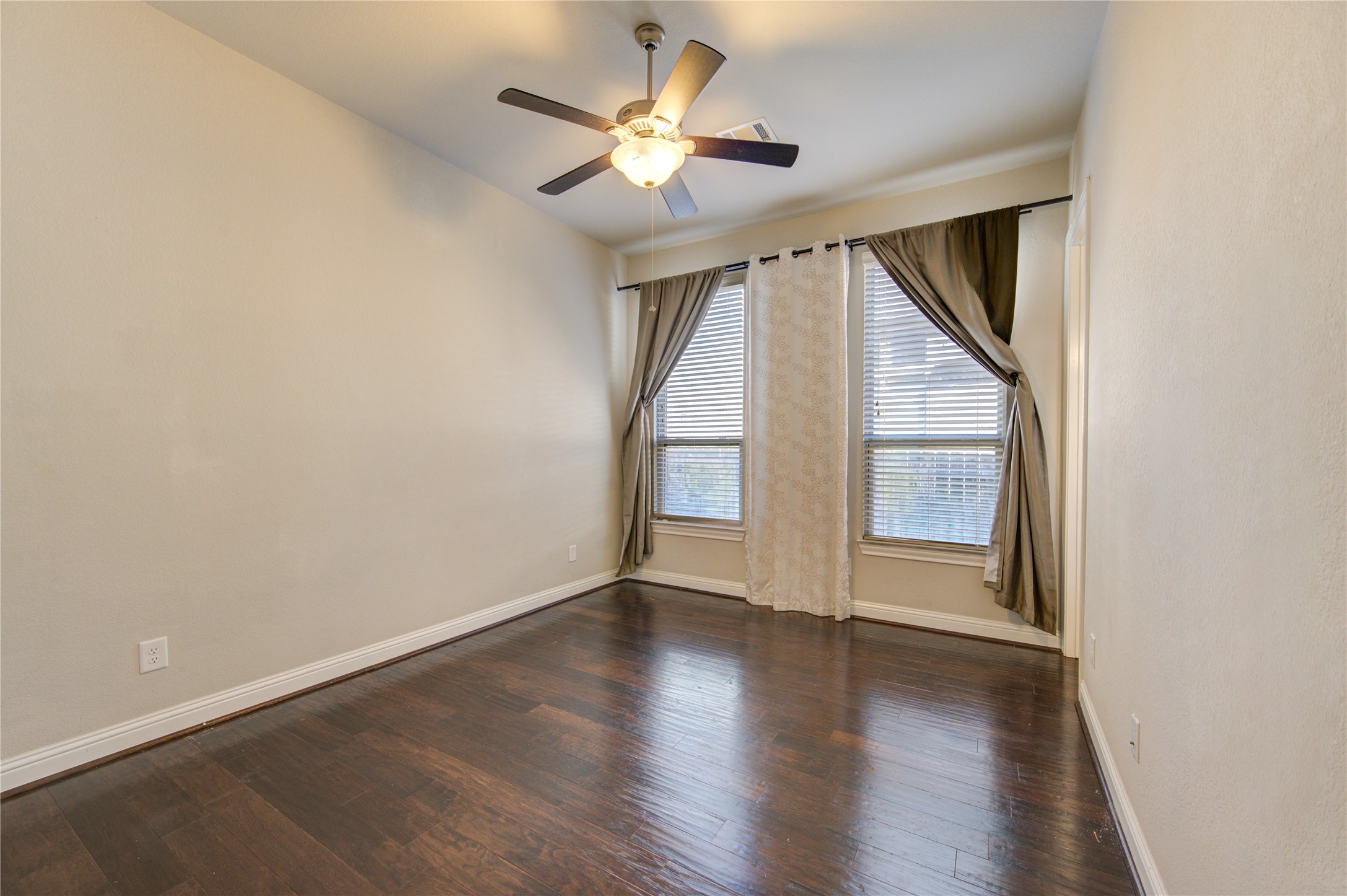 20411 Fawn Rest Place Spring, TX 77379 - Photo 8 of 50 an empty room with wooden floor fan and windows