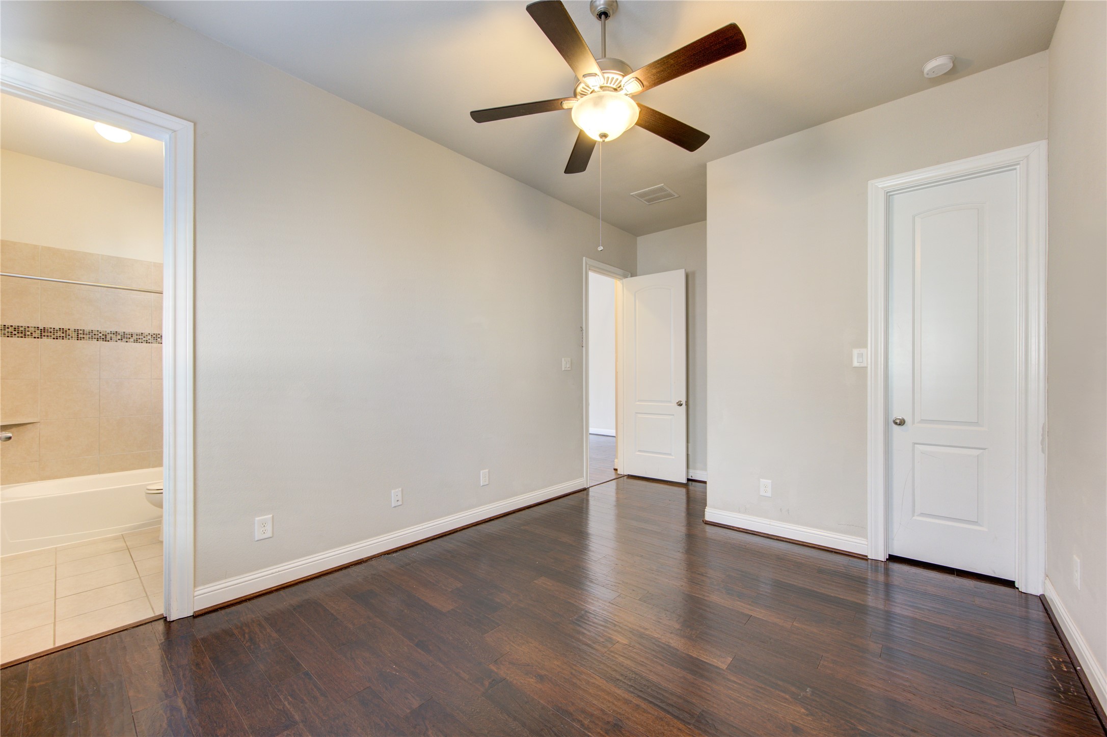20411 Fawn Rest Place Spring, TX 77379 - Photo 9 of 50 an empty room with wooden floor and a ceiling fan