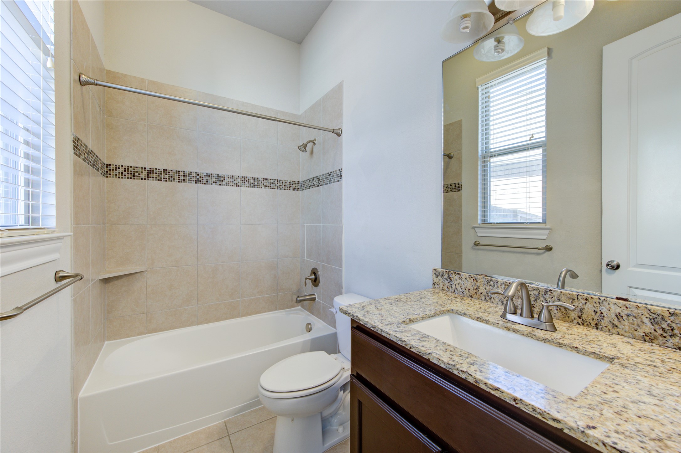 20411 Fawn Rest Place Spring, TX 77379 - Photo 10 of 50 a bathroom with a granite countertop sink a toilet and bathtub