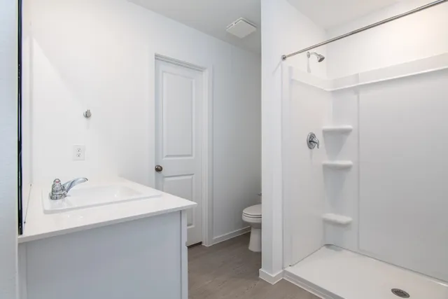 a bathroom with a shower and a toilet