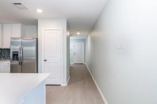 a view of a kitchen with a sink and cabinets