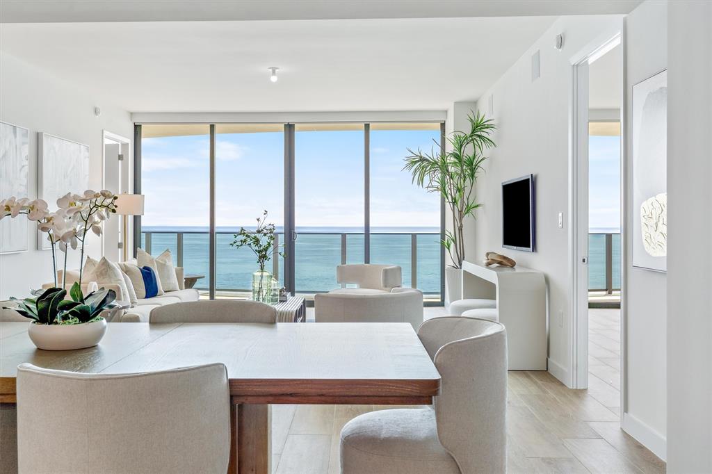 900 North Ocean Boulevard, Unit 1702 Pompano Beach, FL 33062 - Photo 11 of 49 a dining room with furniture a potted plant and a large window