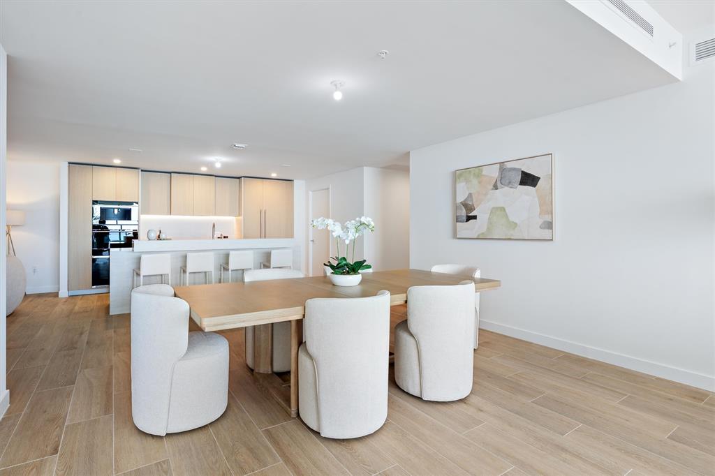 900 North Ocean Boulevard, Unit 1702 Pompano Beach, FL 33062 - Photo 12 of 49 a living room with stainless steel appliances furniture a refrigerator a dining table and chairs