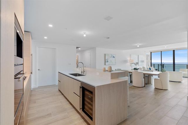 a kitchen with a sink stove and refrigerator