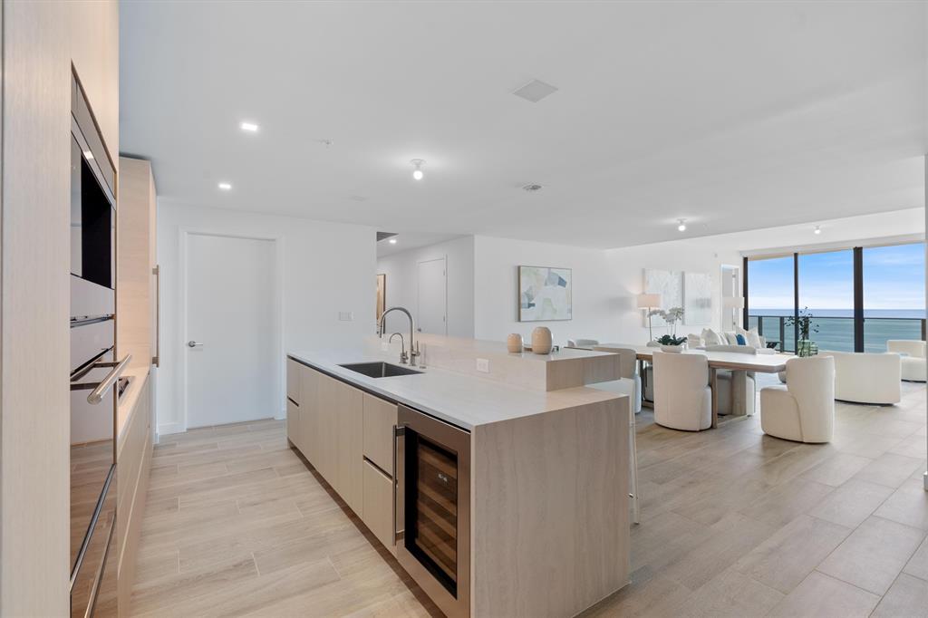 900 North Ocean Boulevard, Unit 1702 Pompano Beach, FL 33062 - Photo 16 of 49 a kitchen with a sink stove and refrigerator