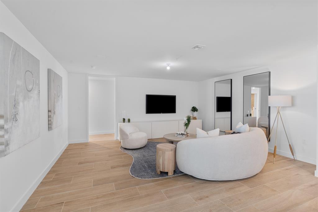 900 North Ocean Boulevard, Unit 1702 Pompano Beach, FL 33062 - Photo 17 of 49 a living room with furniture and a flat screen tv
