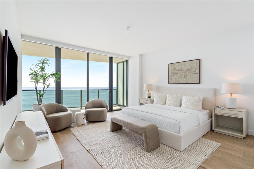 900 North Ocean Boulevard, Unit 1702 Pompano Beach, FL 33062 - Photo 20 of 49 a bedroom with a bed and a large window