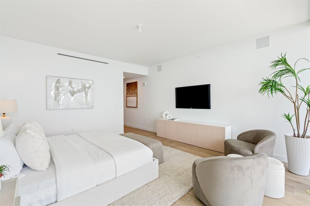 900 North Ocean Boulevard, Unit 1702 Pompano Beach, FL 33062 - Photo 21 of 49 a bedroom with a bed and a flat screen tv