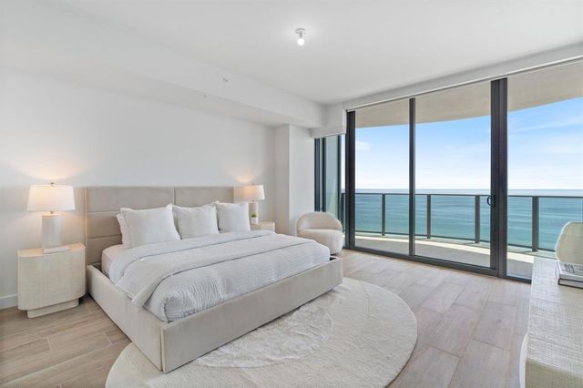 a spacious bedroom with a large bed and a large window