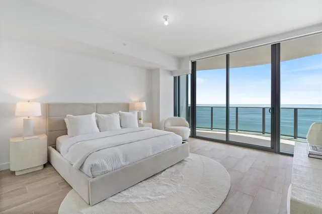 a spacious bedroom with a large bed and a large window