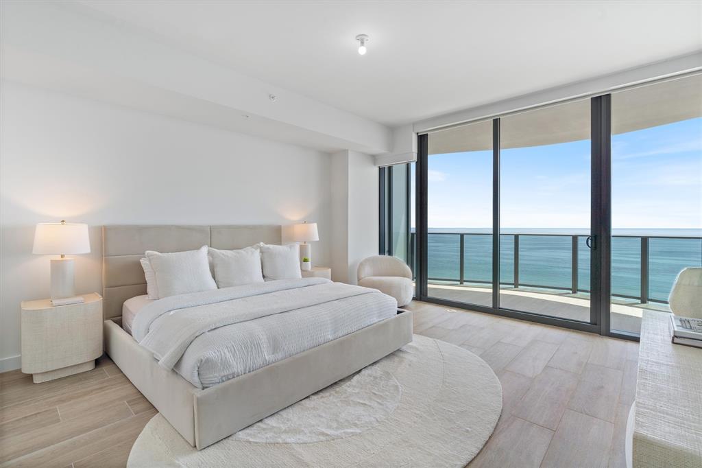 900 North Ocean Boulevard, Unit 1702 Pompano Beach, FL 33062 - Photo 24 of 49 a spacious bedroom with a large bed and a large window