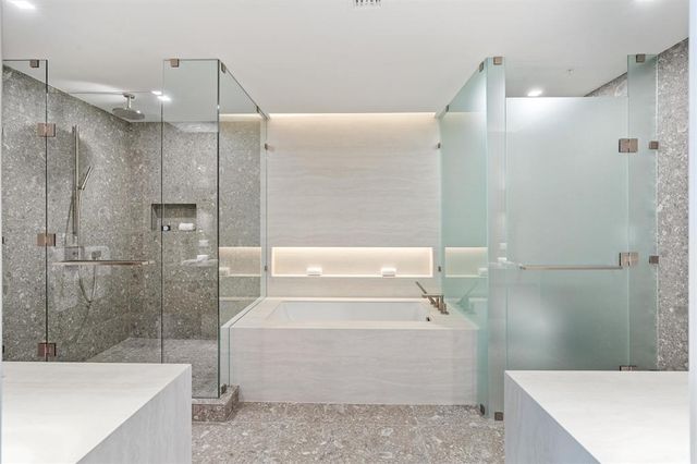 a bathroom with a bathtub and a shower