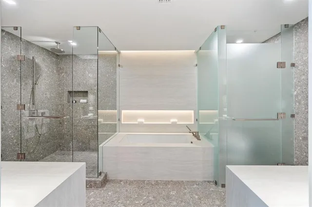 a bathroom with a bathtub and a shower