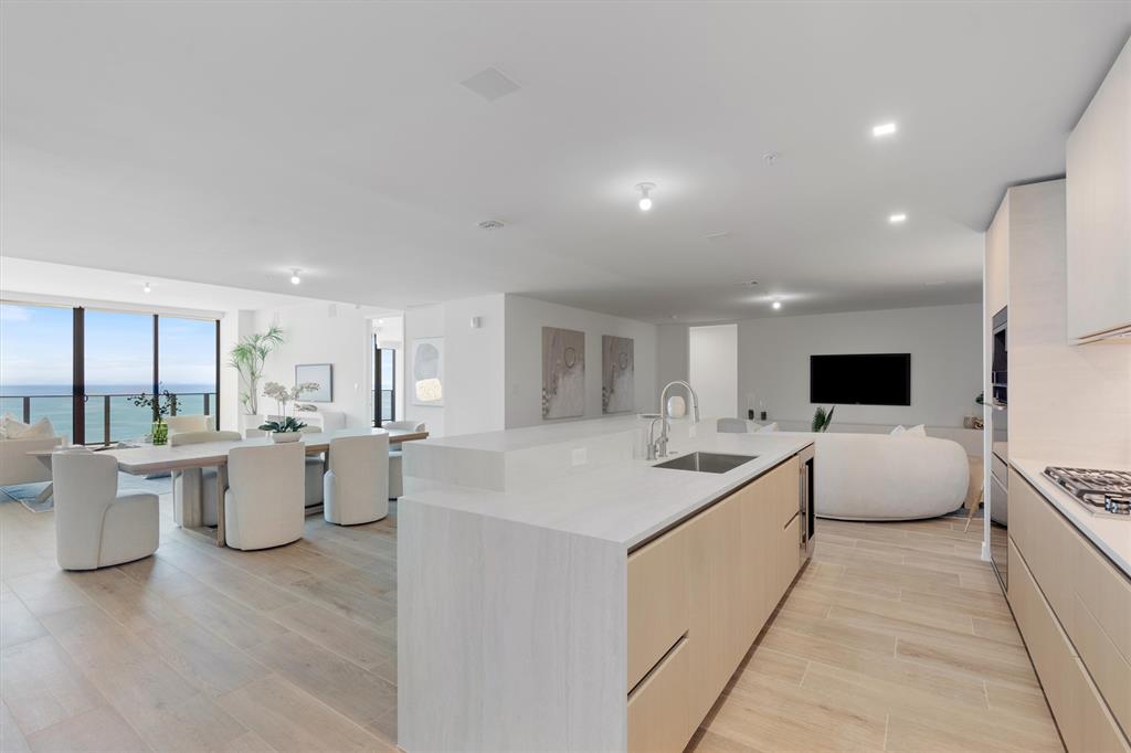 900 North Ocean Boulevard, Unit 1702 Pompano Beach, FL 33062 - Photo 3 of 49 a living room with a couch and a table