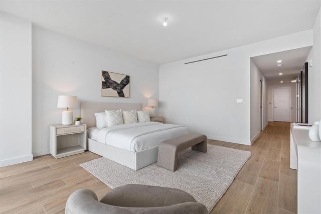 a spacious bedroom with a bed and a couch