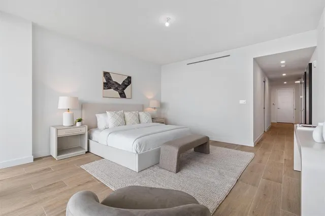 a spacious bedroom with a bed and a couch