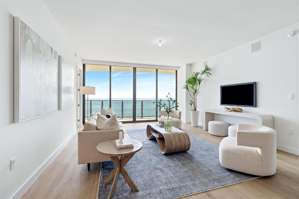 900 North Ocean Boulevard, Unit 1702 Pompano Beach, FL 33062 - Photo 4 of 49 a living room with furniture and a flat screen tv