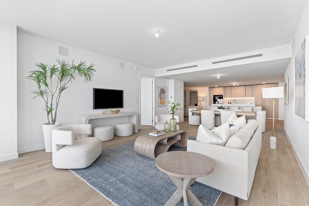 900 North Ocean Boulevard, Unit 1702 Pompano Beach, FL 33062 - Photo 7 of 49 a living room with furniture and a flat screen tv