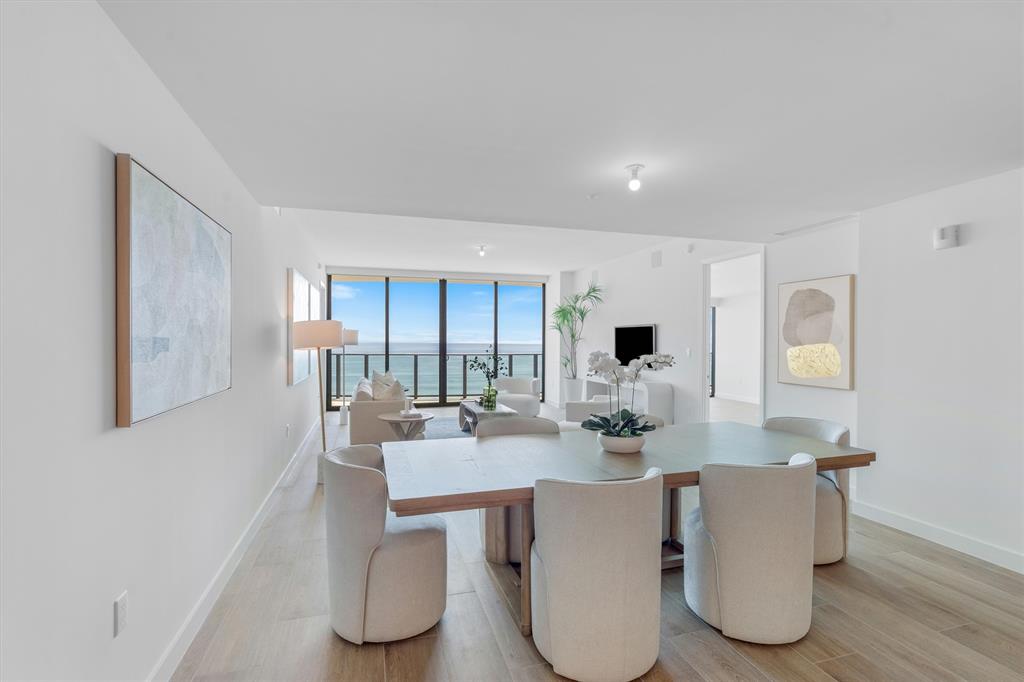 900 North Ocean Boulevard, Unit 1702 Pompano Beach, FL 33062 - Photo 9 of 49 a dining room with table and chairs