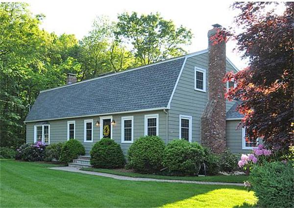 23 Whippletree Road Chelmsford, MA 01824 - Photo 1 of 28 a front view of a house with a yard and potted plants