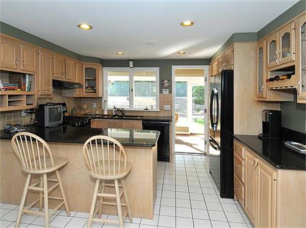 23 Whippletree Road Chelmsford, MA 01824 - Photo 5 of 28 a kitchen with stainless steel appliances a table chairs and a refrigerator